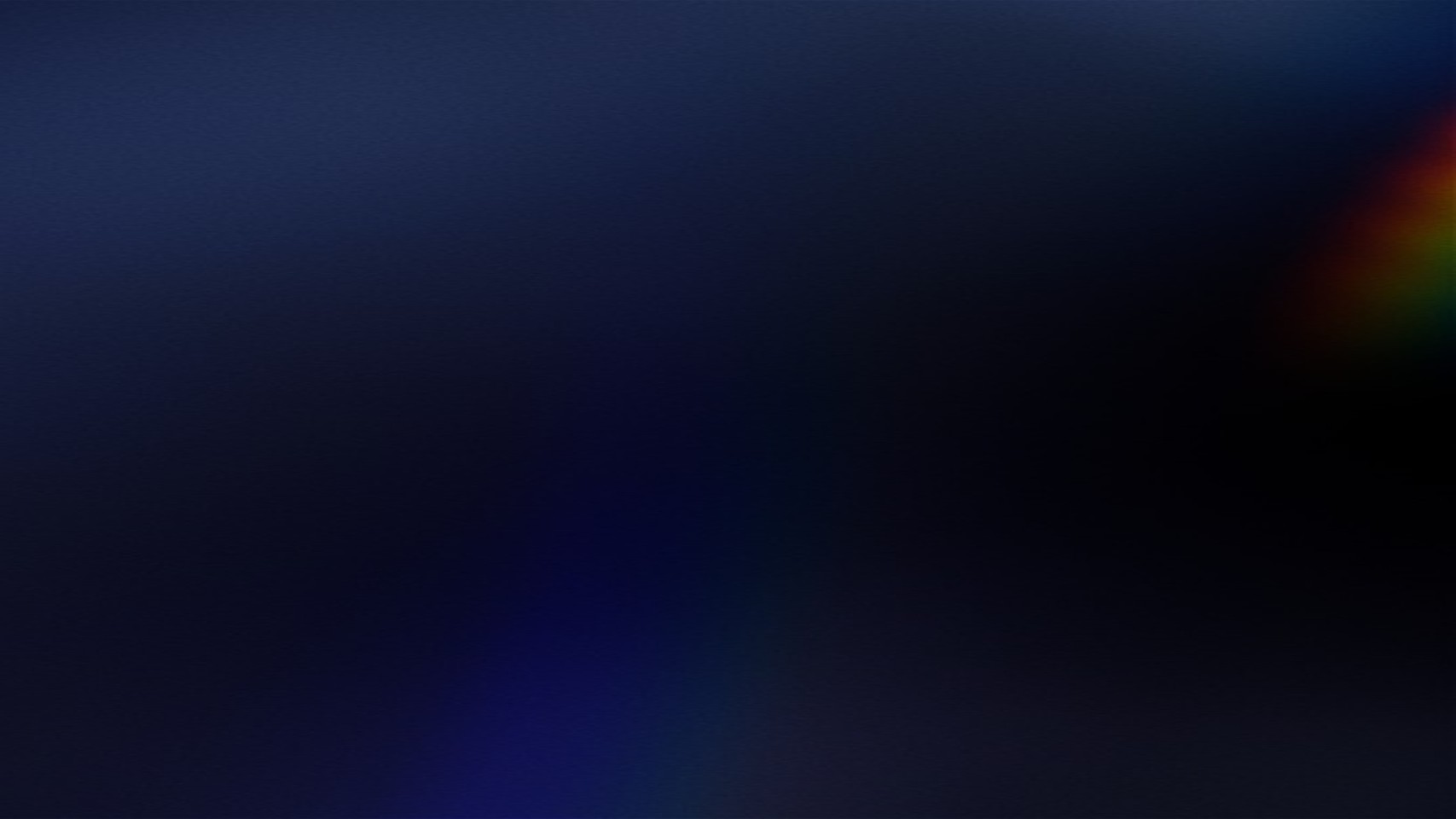 Two women sitting at a modern table talking with a city view behind them.